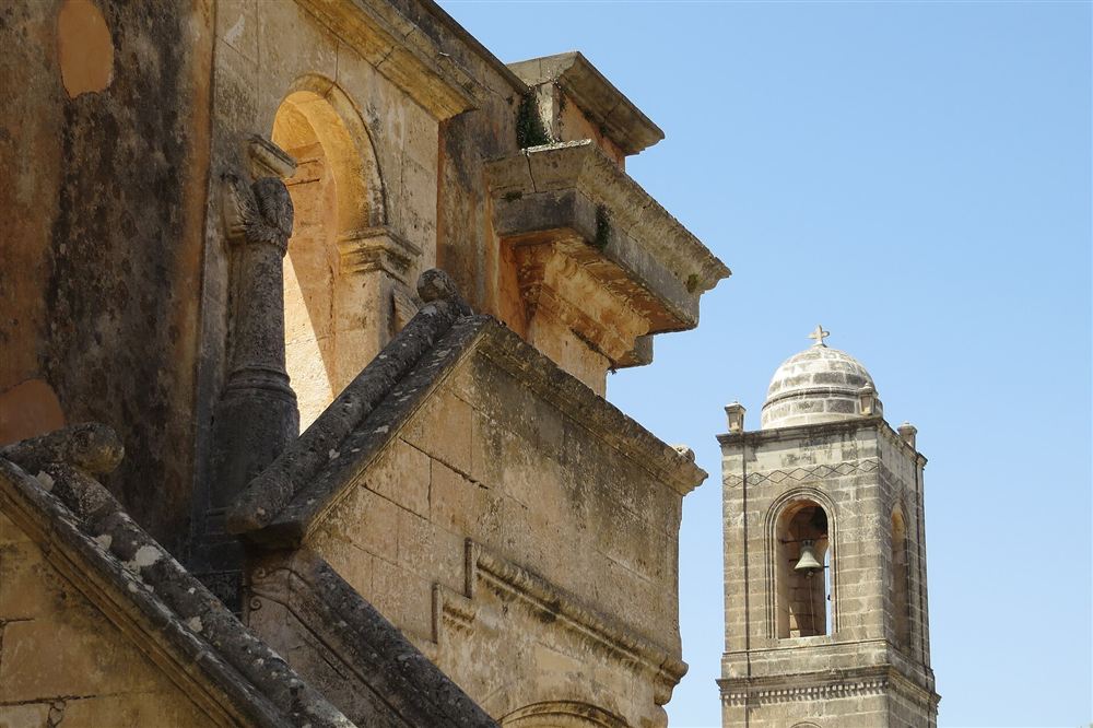 The carved stone facade and bell tower of the Agia Triada monastery church on the Akrotiri peninsula of Crete