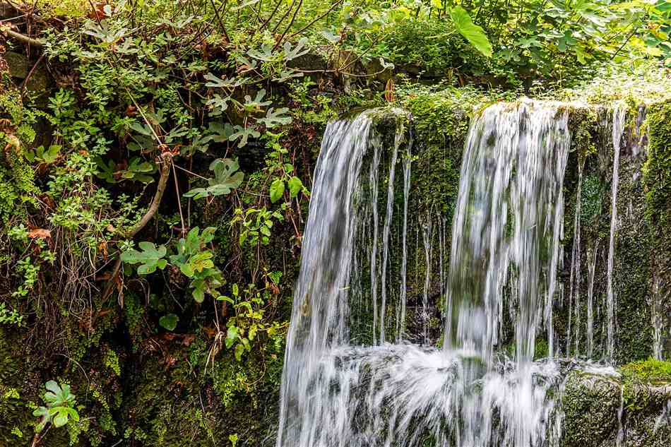The cascading spring waterfalls under plane trees at Argyroupoli in the Rethymno hills of Crete