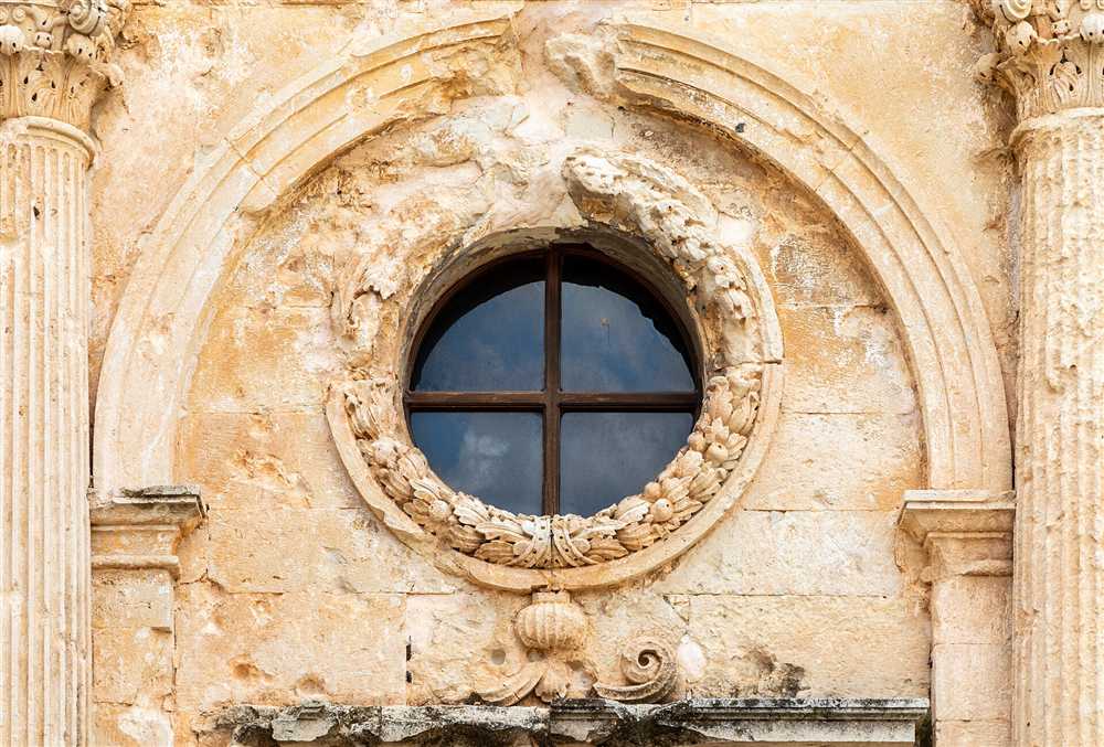 A carved stone rose window on the baroque church facade of Arkadi Monastery in Crete