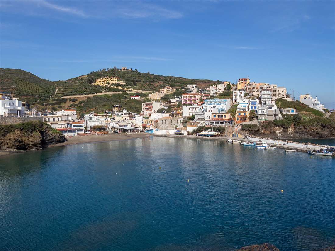 The harbour cove of Bali on the north coast of Crete, its whitewashed village climbing the headland above turquoise water
