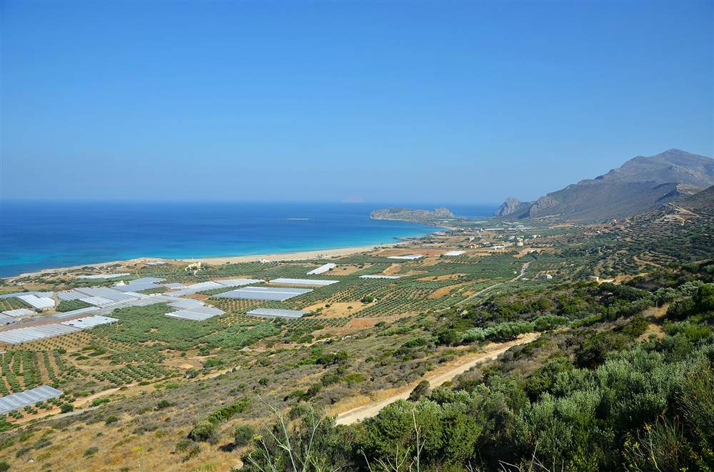 The long sandy beach and turquoise water of Falassarna on the west coast of Crete, seen from the hills