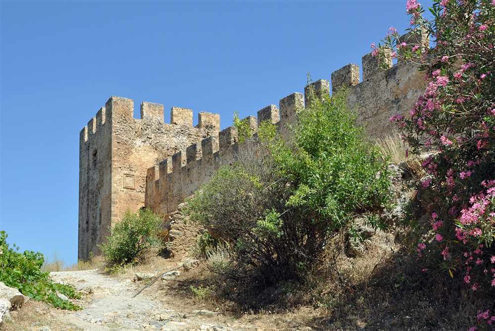 The crenellated walls and corner tower of the Venetian fortress of Frangokastello, Crete