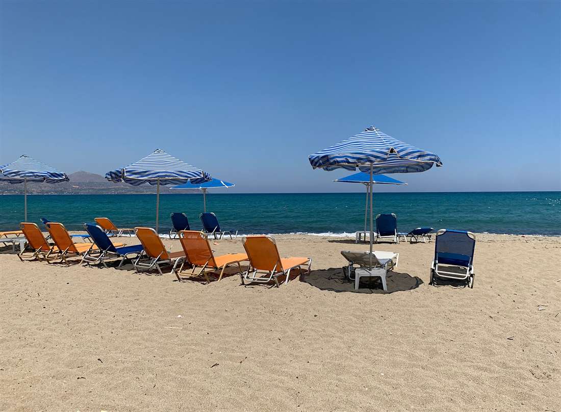 The sandy beach and turquoise water at Kalives on the east side of Souda Bay in the Apokoronas, Crete