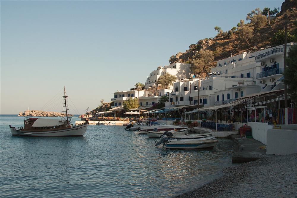 The waterfront of the car-free village of Loutro, Crete, with its tavernas and moored boats