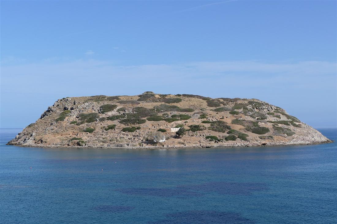 The Minoan island of Mochlos off the north-east coast of Crete, its Bronze-Age ruins on the slope above the sea