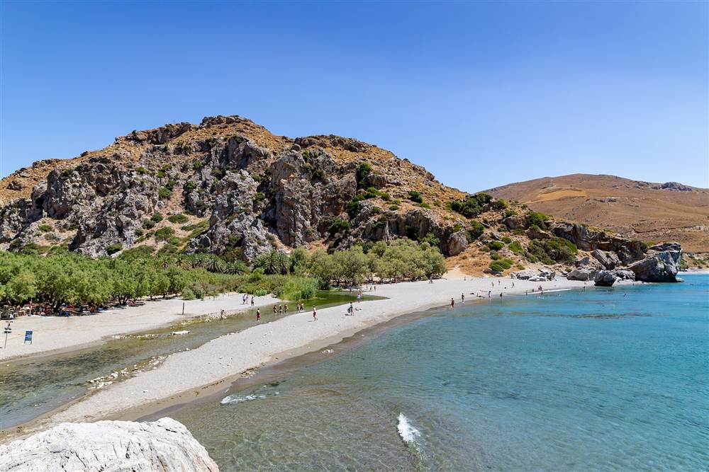 The sandbar and freshwater river at Preveli palm beach below the headland, Crete
