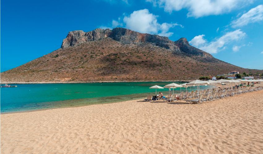 The bare Vardies mountain rising behind the lagoon beach at Stavros, backdrop of the Zorba sirtaki dance, in Crete