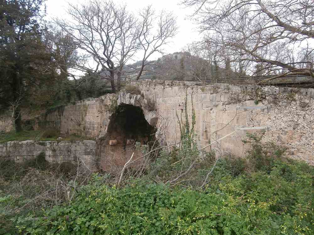 An old stone arch bridge among the plane trees at Vryses in the Apokoronas of Crete