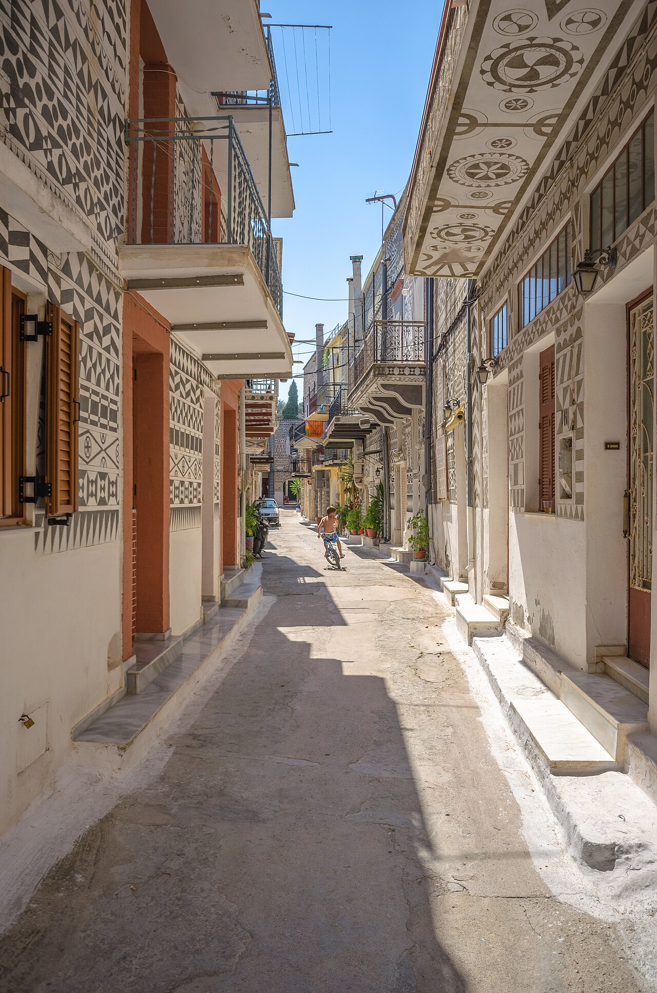 A narrow street in the mastic village of Pyrgi, where cars park outside the walls