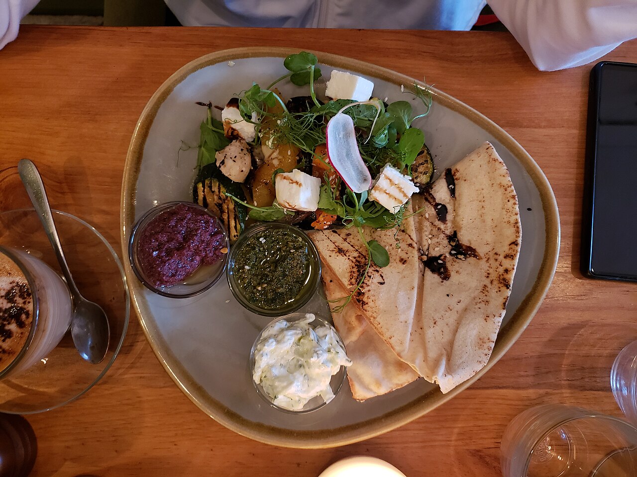 A Greek meze platter of grilled vegetables, dips, feta and flatbread, the taverna style found across Chios