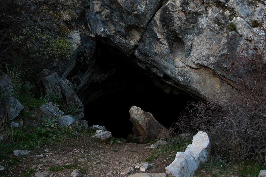 The dark mouth of the Corycian Cave in the limestone rock high on Mount Parnassus above Delphi