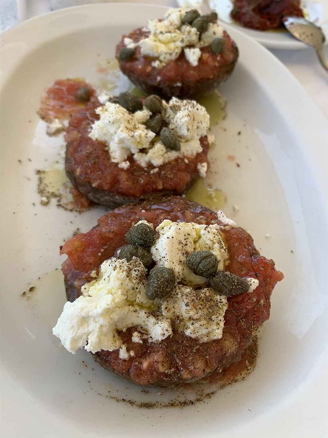 Cretan dakos with tomato, mizithra and capers, a classic dish to eat in Chania
