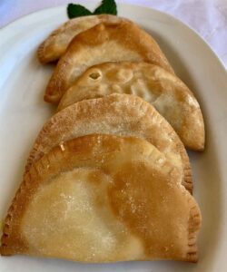 Fried Cretan kalitsounia cheese pies served in Chania