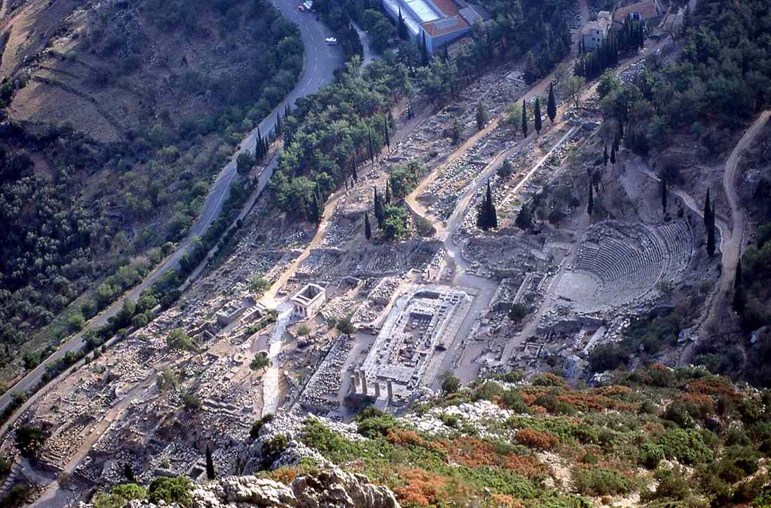 Aerial view of the Delphi archaeological site, with the Temple of Apollo, the theatre and the Sacred Way climbing the slope of Mount Parnassus