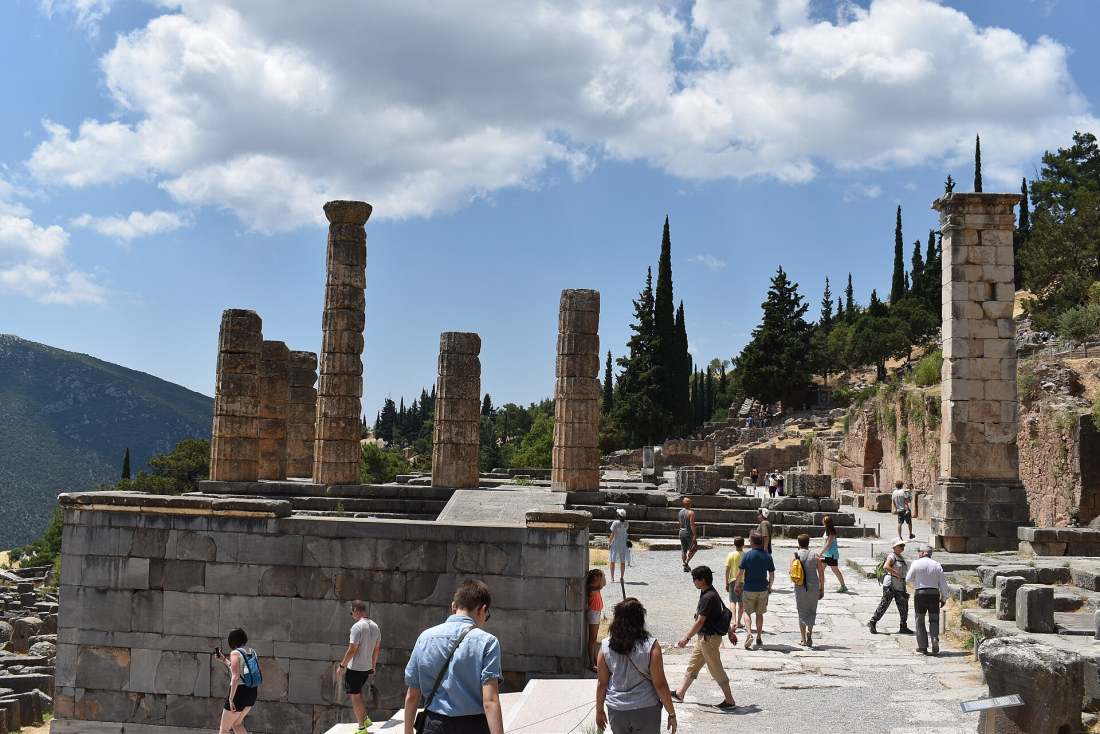 The Temple of Apollo and the archaeological site of Delphi with visitors on the Sacred Way
