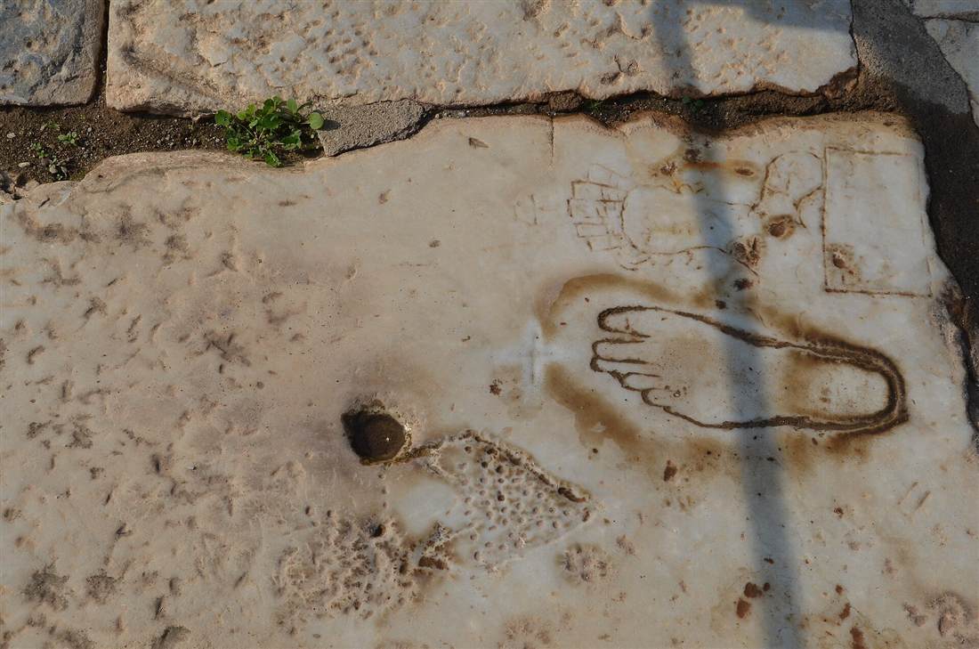 The footprint advertisement carved in Marble Street pointing to the brothel of Ephesus