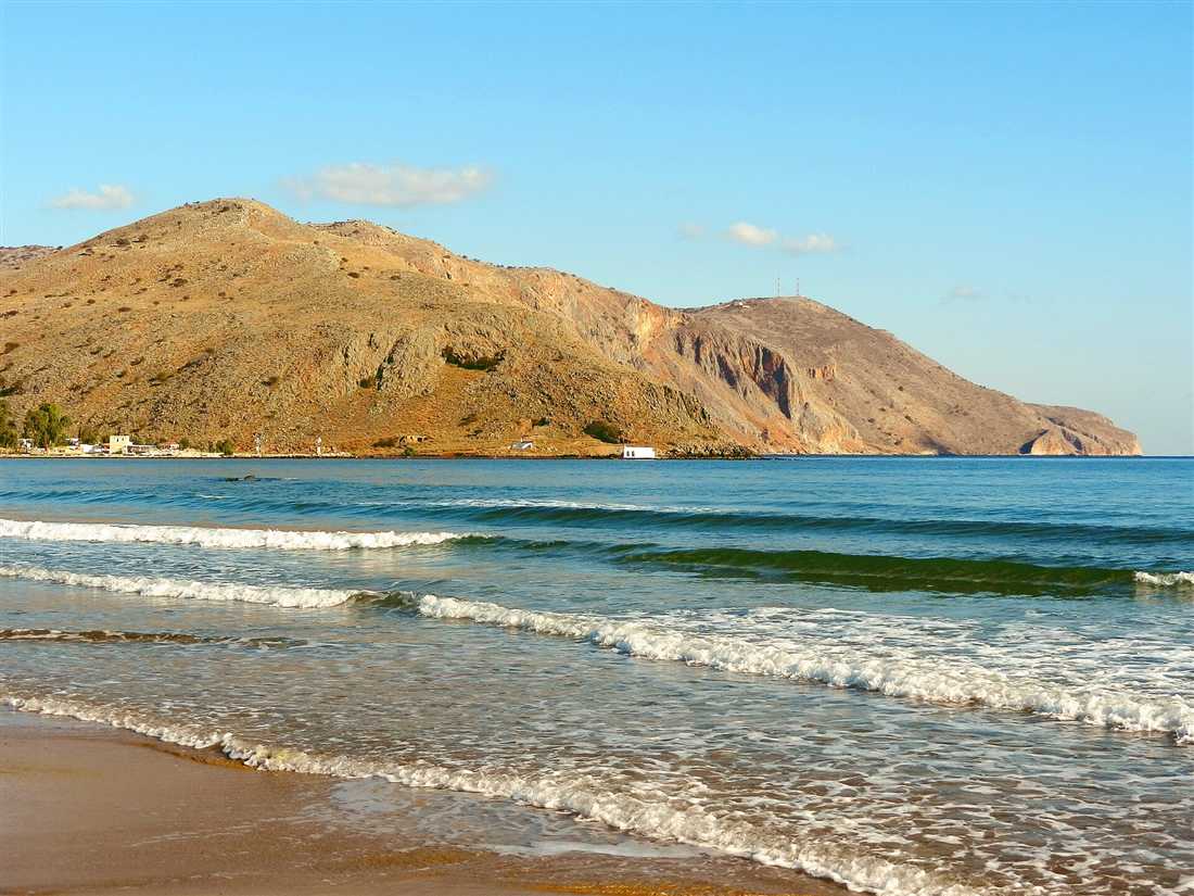 The golden-sand Georgioupolis beach with the headland and the Agios Nikolaos chapel, Crete