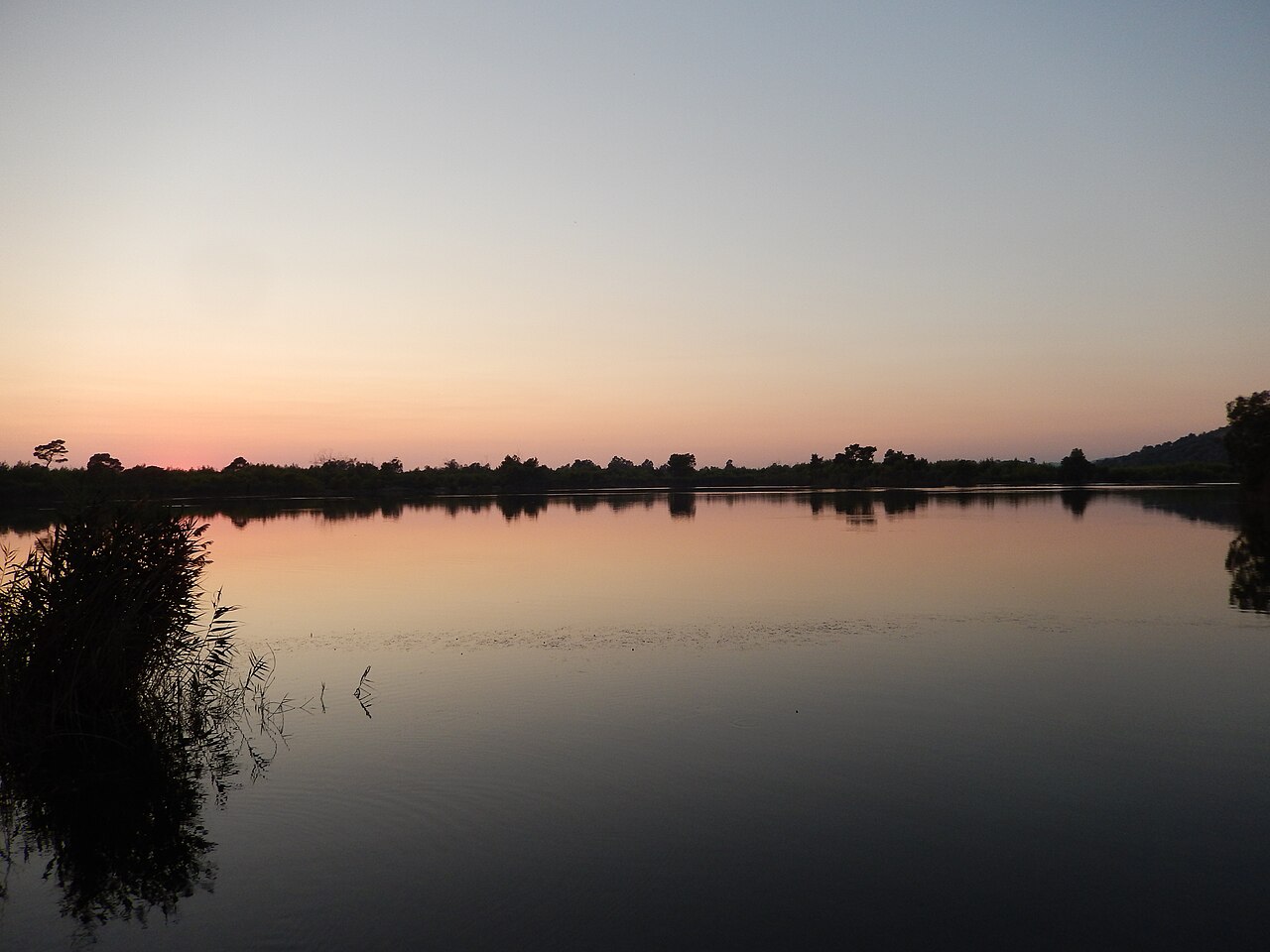 The tranquil waters of Kaiafas Lake at the foot of Mount Lapithas in the western Peloponnese
