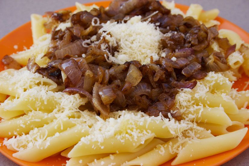 A plate of makarounes, the hand-rolled pasta of Karpathos, with fried onion and cheese
