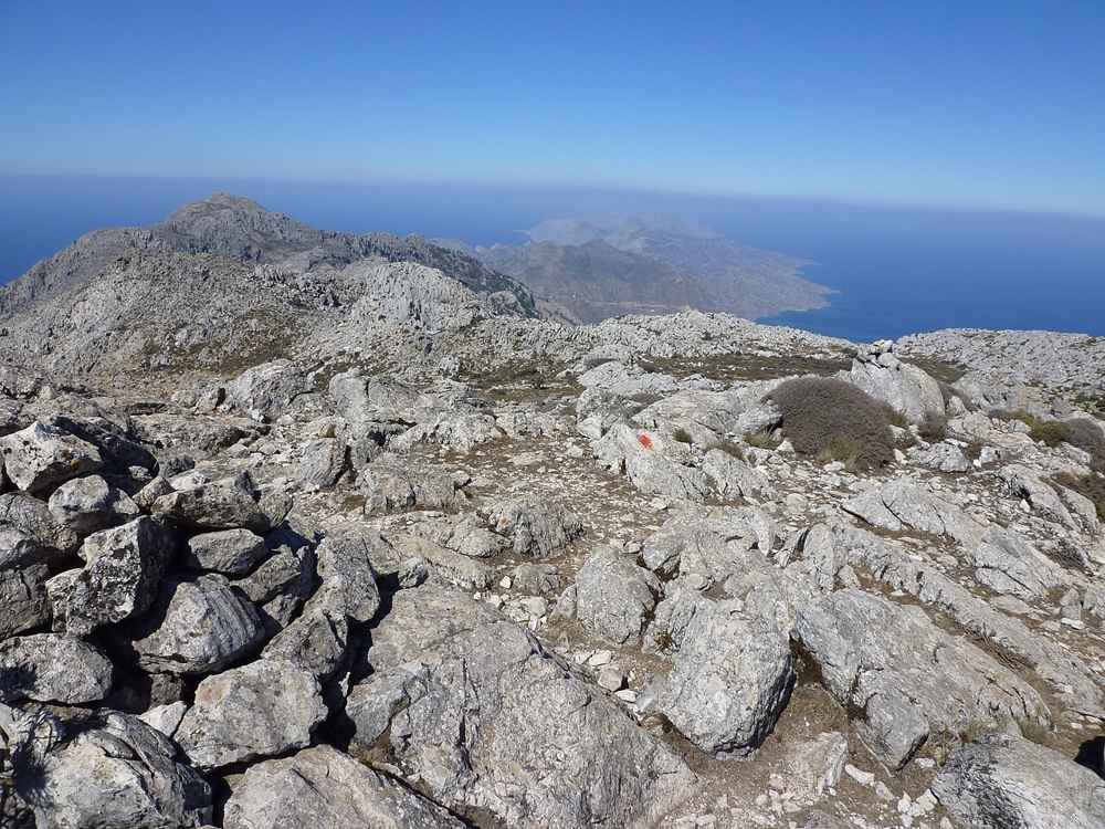 A red waymark on the rocky summit ridge of Kali Limni, the highest peak of Karpathos