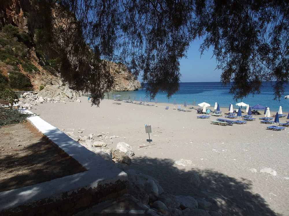 Kyra Panagia beach on Karpathos, its sand shaded by tamarisk trees above turquoise water
