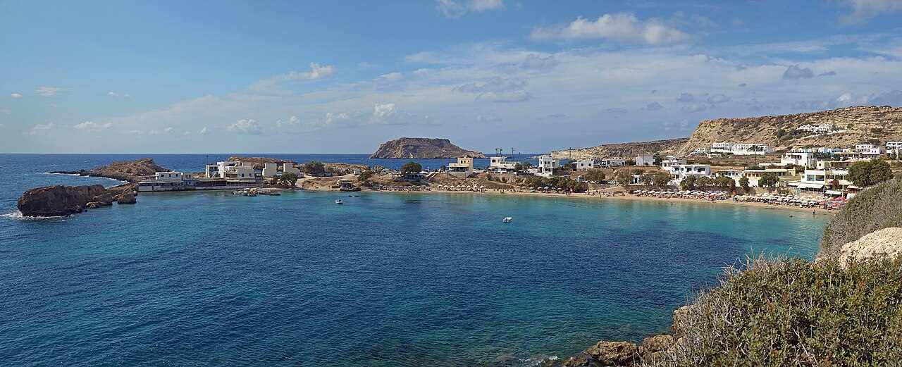 The bay and village of Lefkos with the islet of Sokastro, west coast of Karpathos