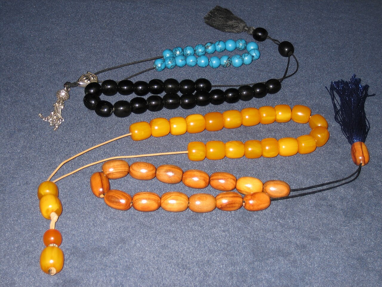 Four komboloi worry beads of different materials