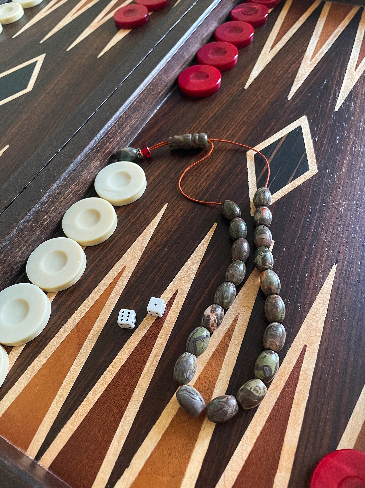 A komboloi resting on a backgammon board