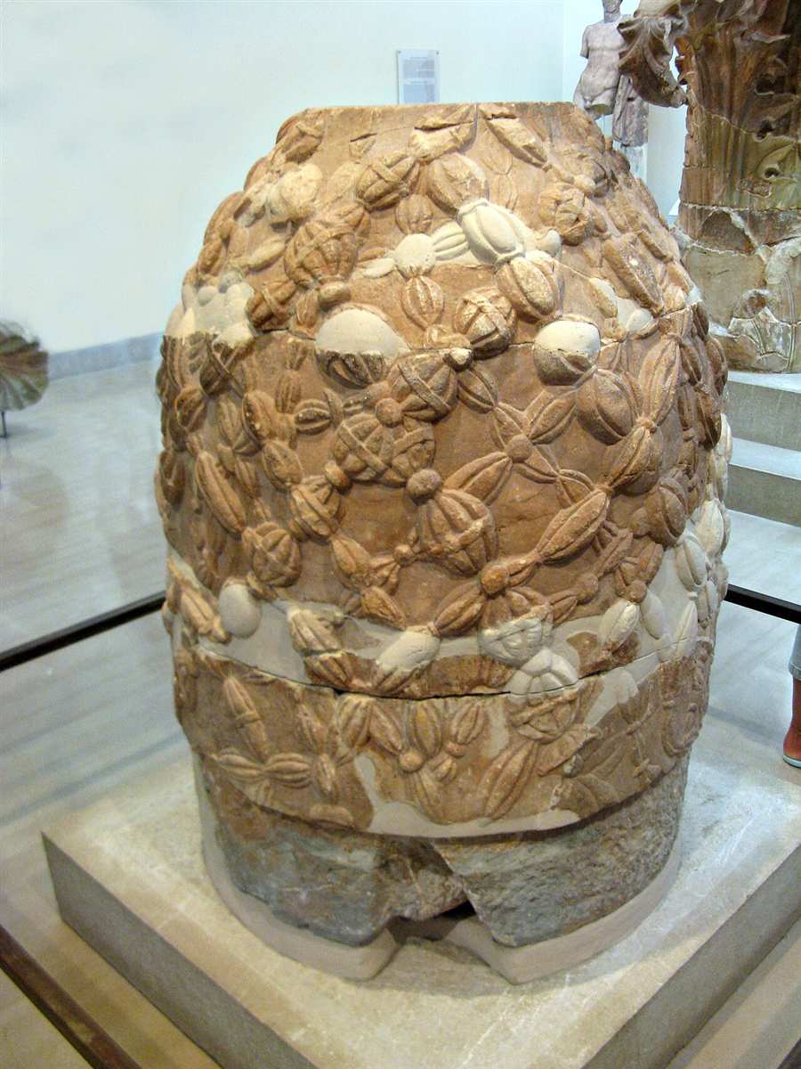 The carved marble omphalos of Delphi in the archaeological museum, its surface cut with the net of woollen fillets