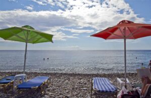 The pebbly Halikia beach with colourful umbrellas at Paleochora, Crete