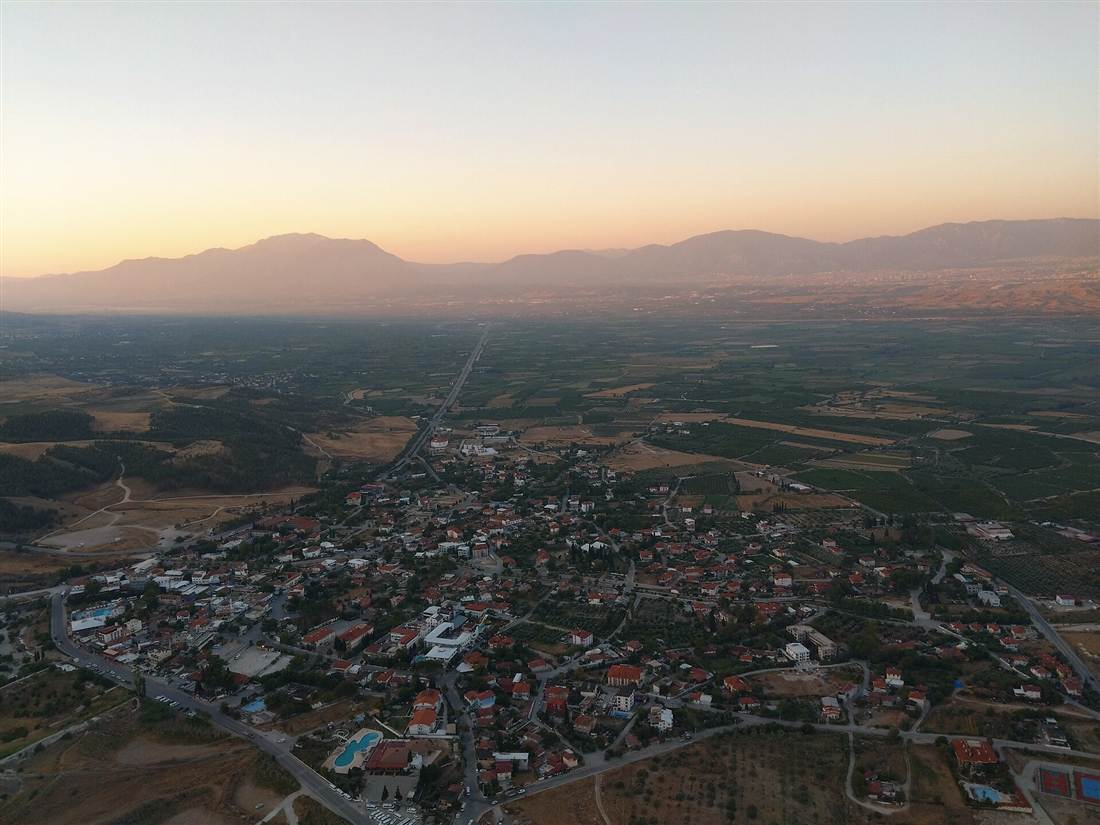 The aerial view over the Pamukkale valley from a hot air balloon at dawn