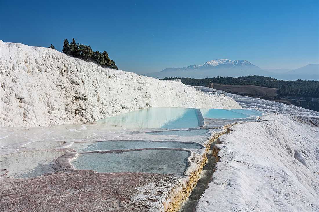 The white travertine terraces and turquoise thermal pools of Pamukkale