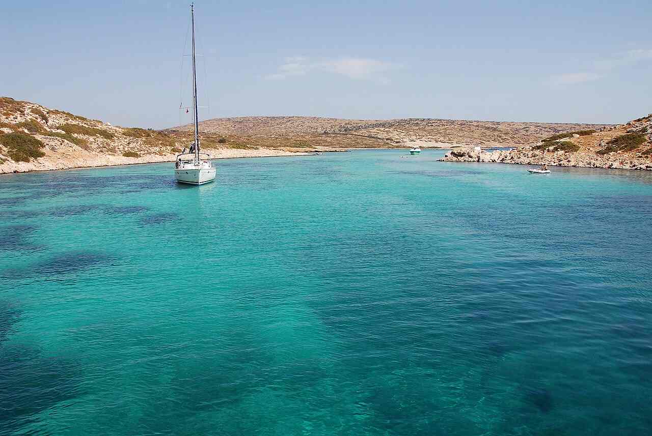 A yacht in the turquoise water off the islet of Arki, near Patmos