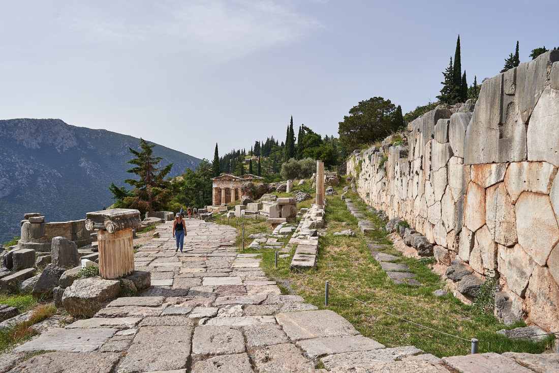 The paved Sacred Way at Delphi lined by the polygonal wall and the Treasury of the Athenians