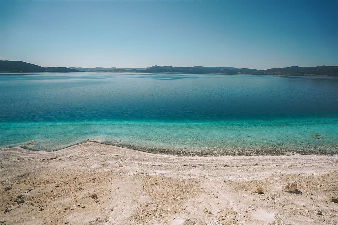 The turquoise water and white mineral shore of Salda Lake in Burdur