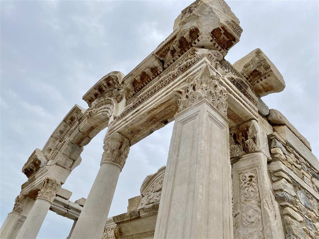 The ornate carved facade and arch of the Temple of Hadrian on Curetes Street at Ephesus
