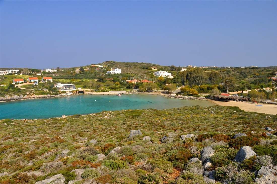 Tersanas beach, Akrotiri, Crete: the sheltered turquoise cove, sandy beach and taverna seen from above