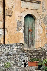 An old stone house with a weathered door in Vamos, Crete