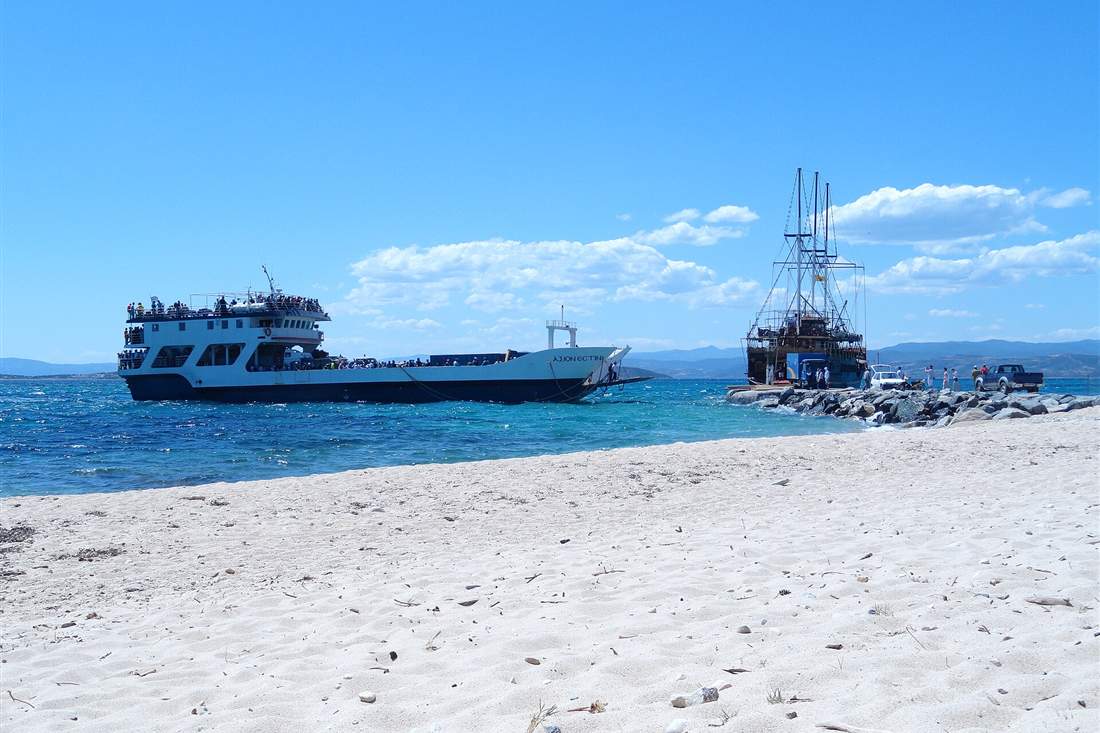 Ammouliani cruise boats anchored off the white sand of the Athos coast