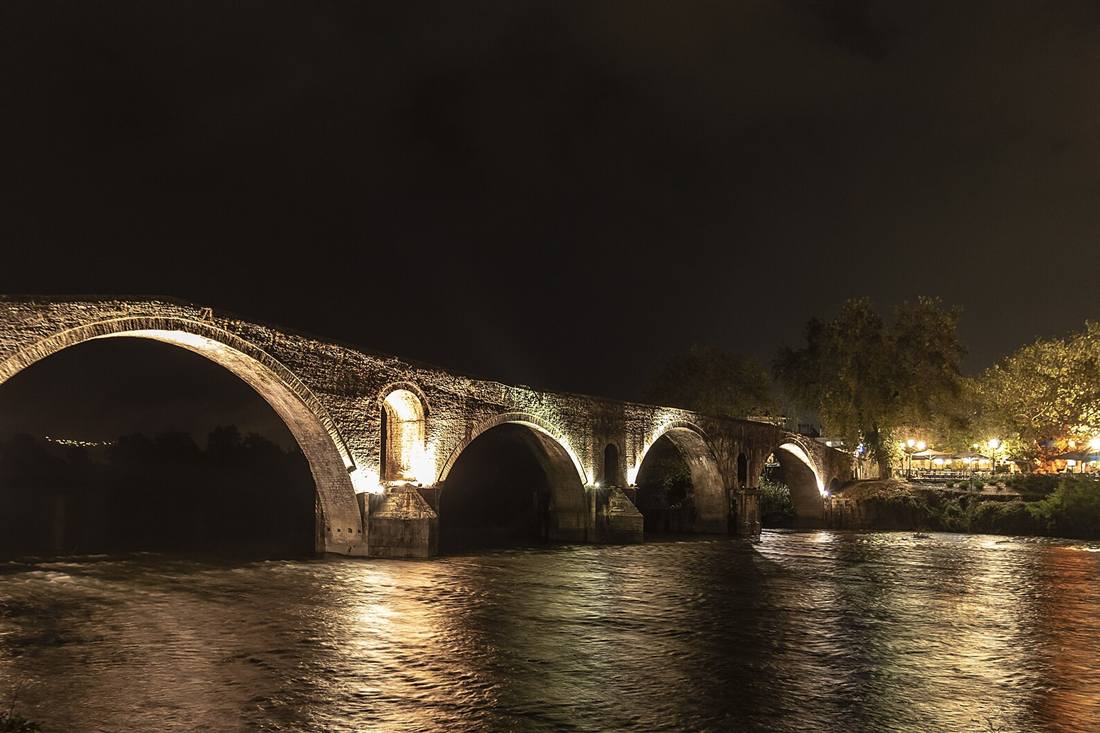 The four-arched stone bridge of Arta lit over the Arachthos