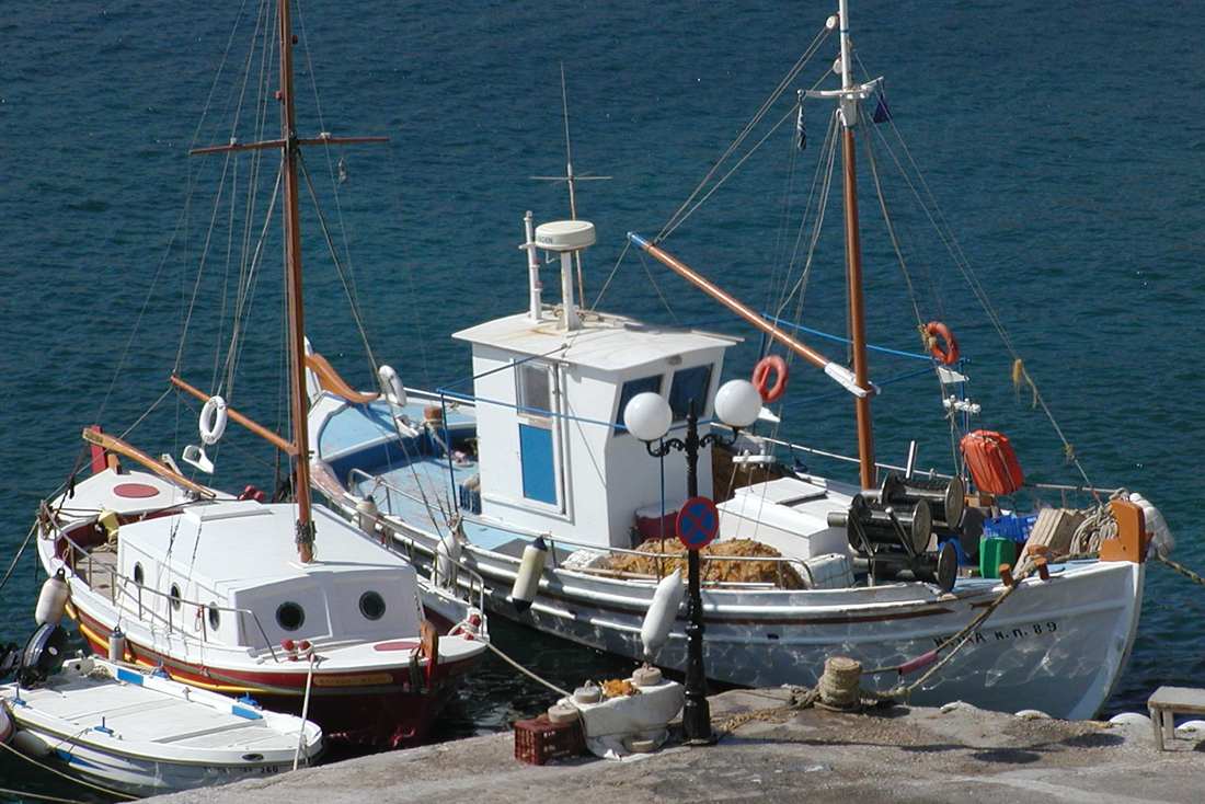 Traditional Greek kaiki fishing boat moored in a harbour