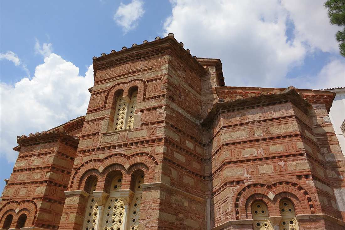 The brick and stone exterior of the Osios Loukas monastery church in Boeotia