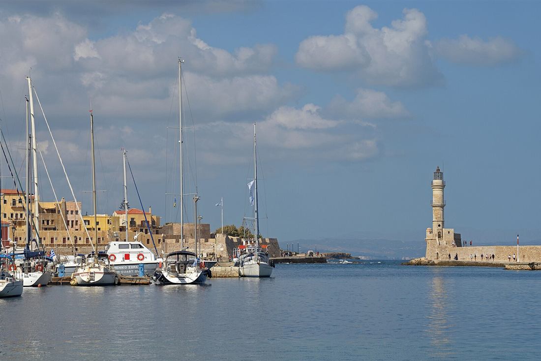 Boats moored in the Venetian harbour of Chania below the Egyptian lighthouse