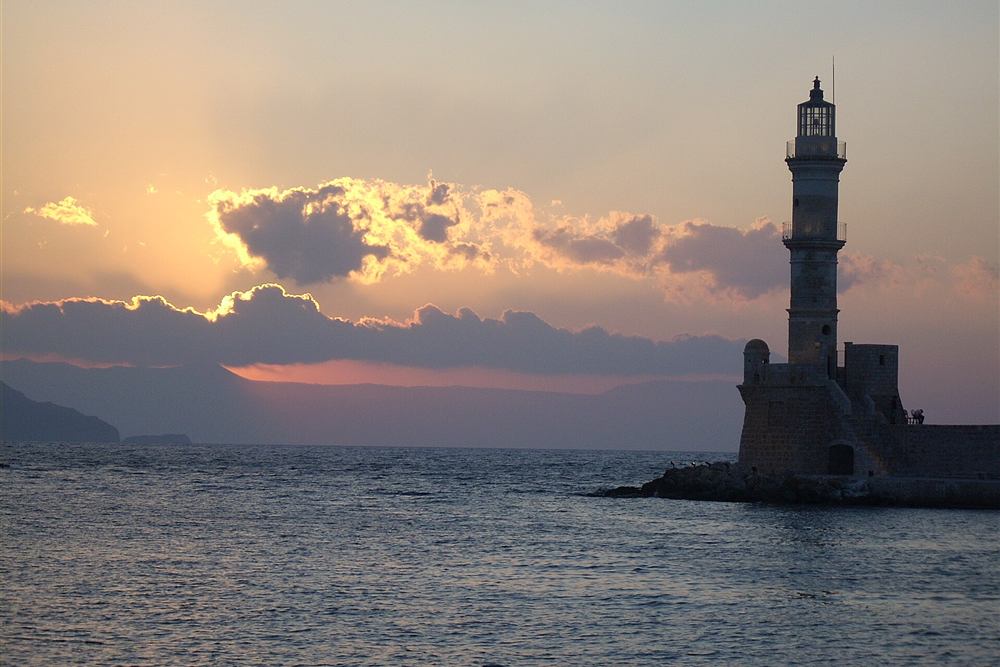 Chania sunset cruise view of the Venetian lighthouse at sunset