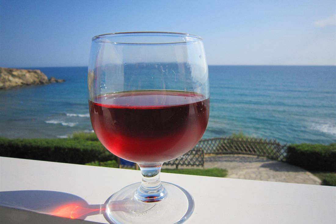 Glass of Cretan rose wine above the sea in Crete