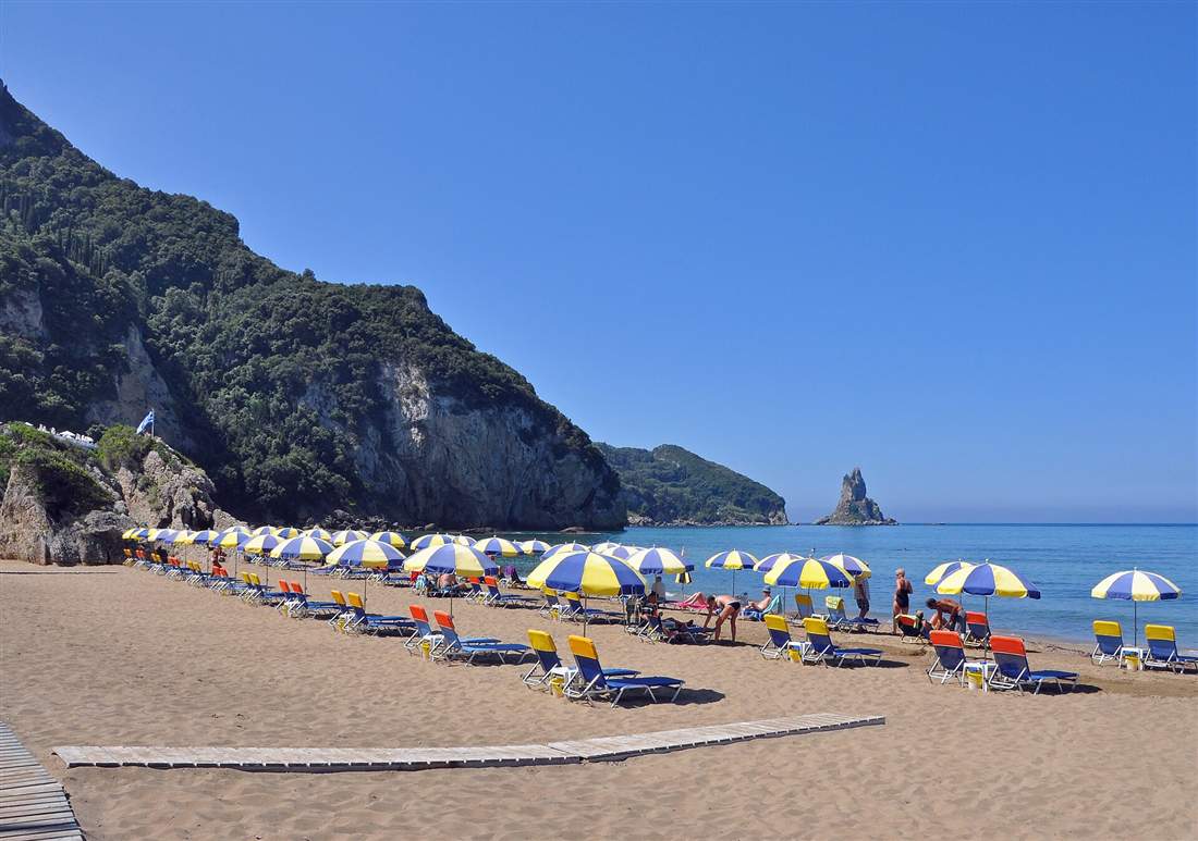The sandy bay and green cliffs of Agios Gordios on the west coast of Corfu, the base for a Corfu ATV quad tour