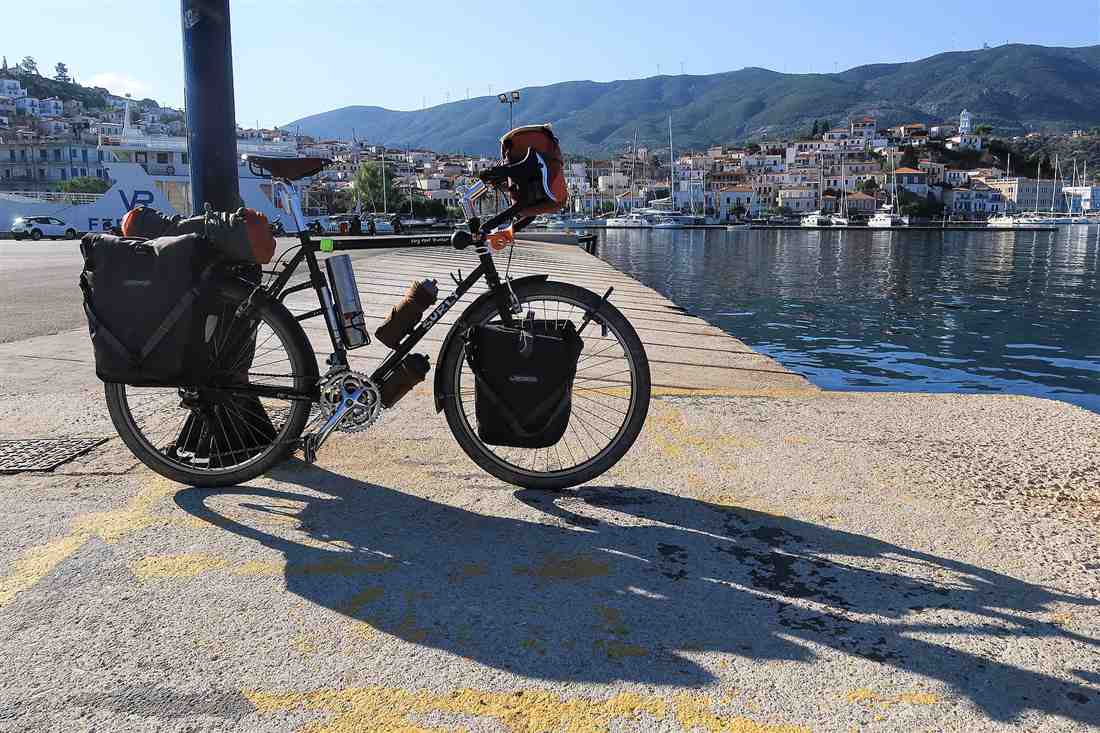 Corfu e-bike tour: a touring bike with panniers parked on a Greek island harbour quay
