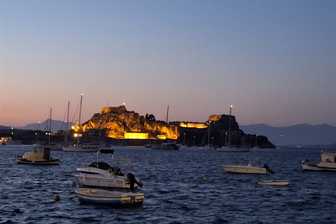 Corfu night tour: the Old Fortress of Corfu lit up at dusk above the harbour