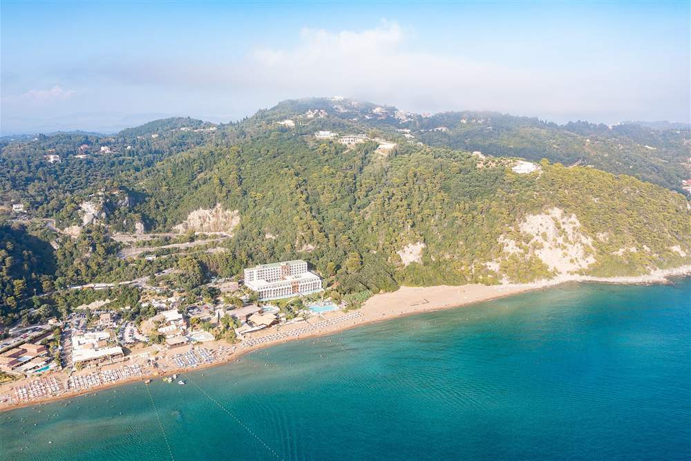 Aerial view of Glyfada beach and the green hills of the Corfu west coast below Pelekas