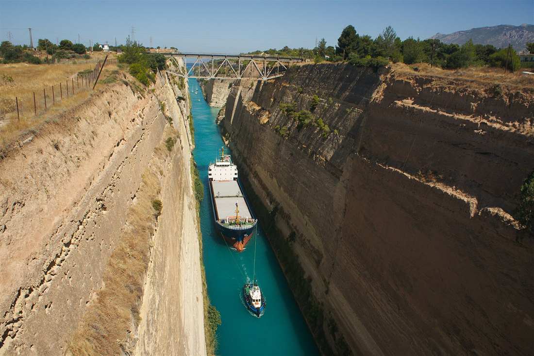 A coaster under tow through the Corinth Canal on a day trip from Athens